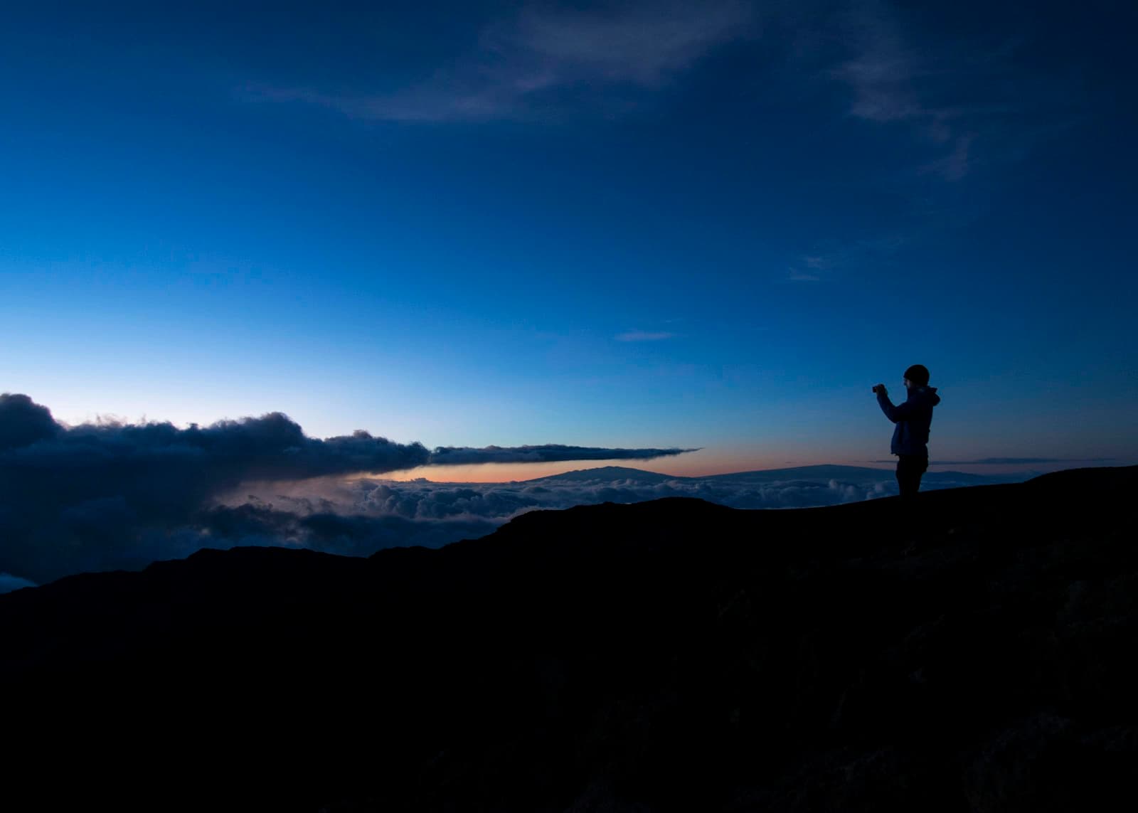 Person looking out at mountain sunset — the horizon of retirement